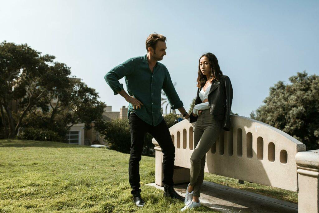 An Upset Woman Looking on the Ground while Having a Misunderstanding with Man