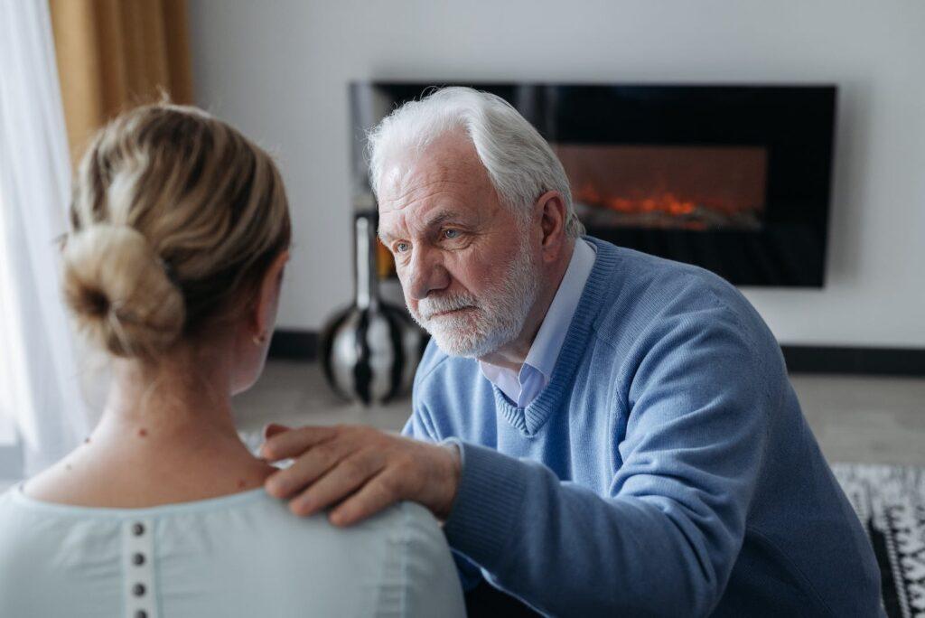 Elderly Man Comforting a Woman