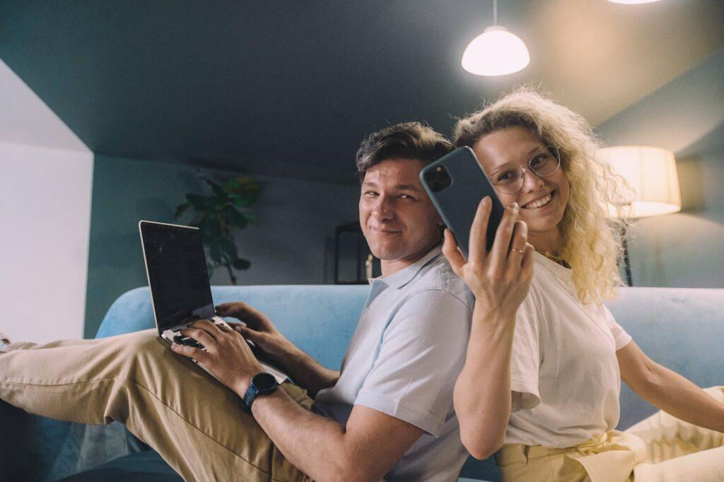 Man in White Crew Neck T-shirt Holding Black Smartphone