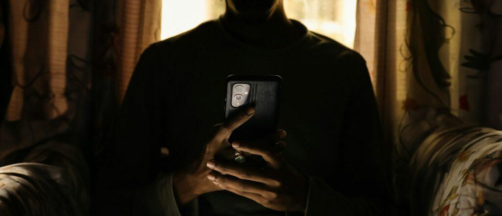 a person holding a cell phone in their hands