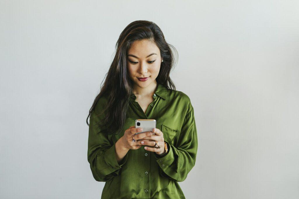 Happy woman texting on a phone