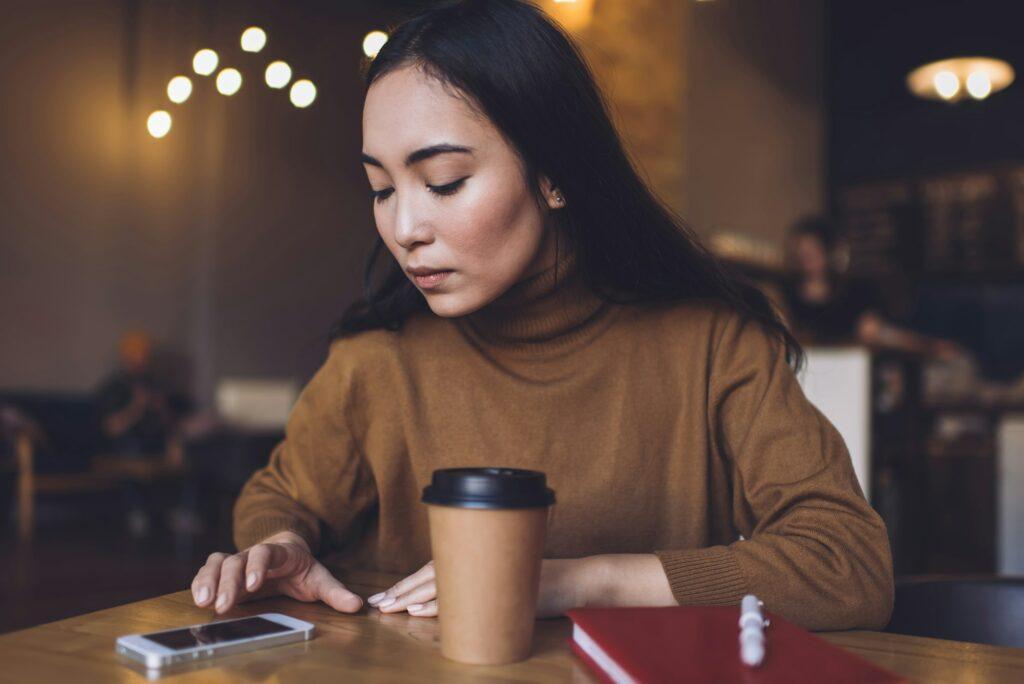 Millennial girl sending mobility sms while networking website