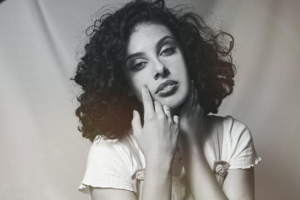 a black and white photo of a woman with curly hair