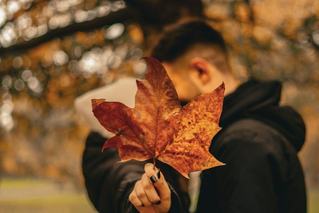 a man holding a leaf in his hand