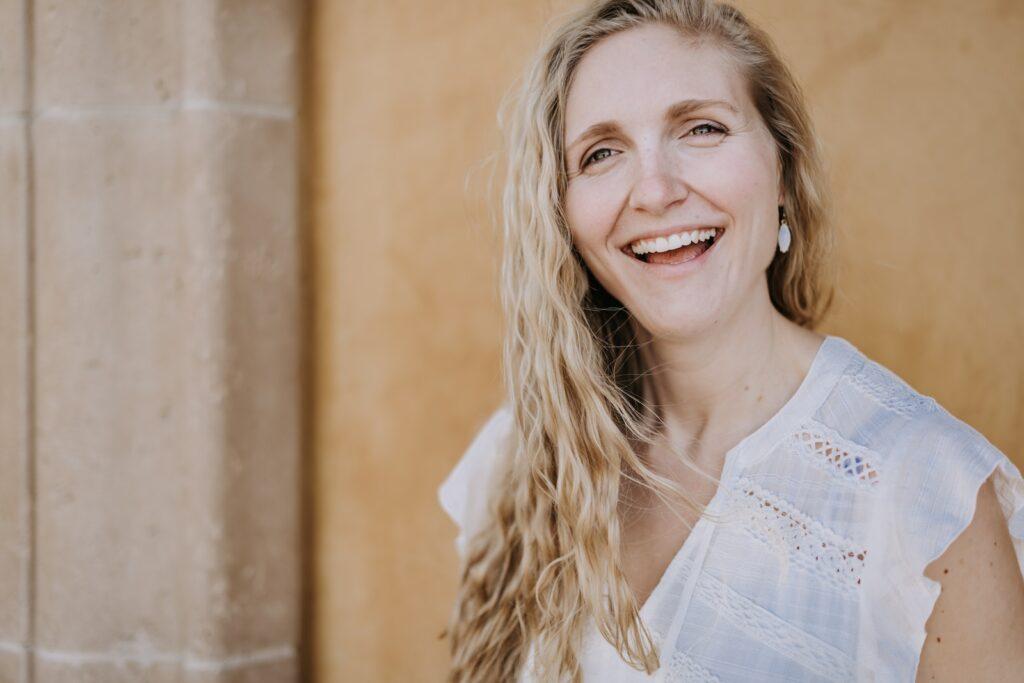 smiling woman in white lace shirt