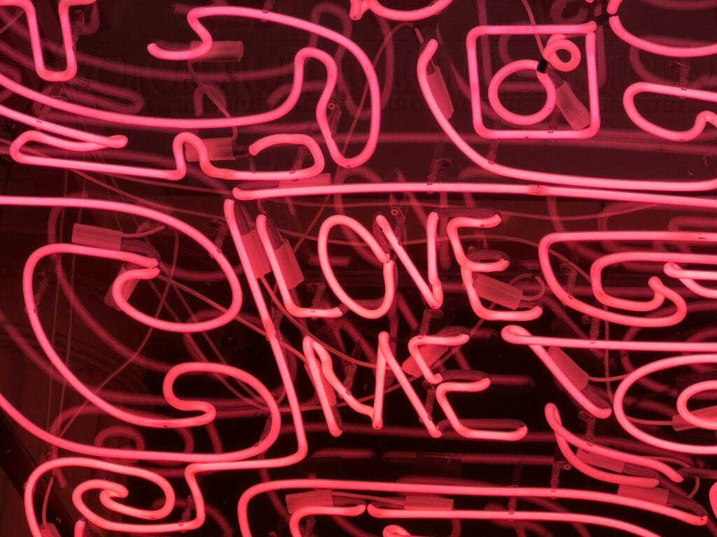 a neon sign that says love me